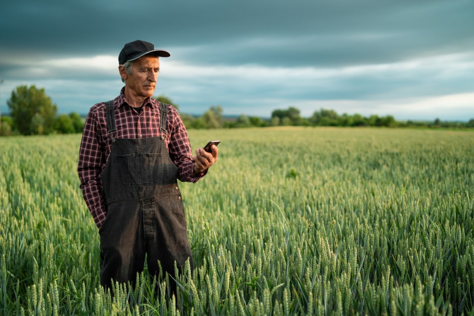 Senior farmer on phone in field (valentinrussanov-E+-Getty Images)
